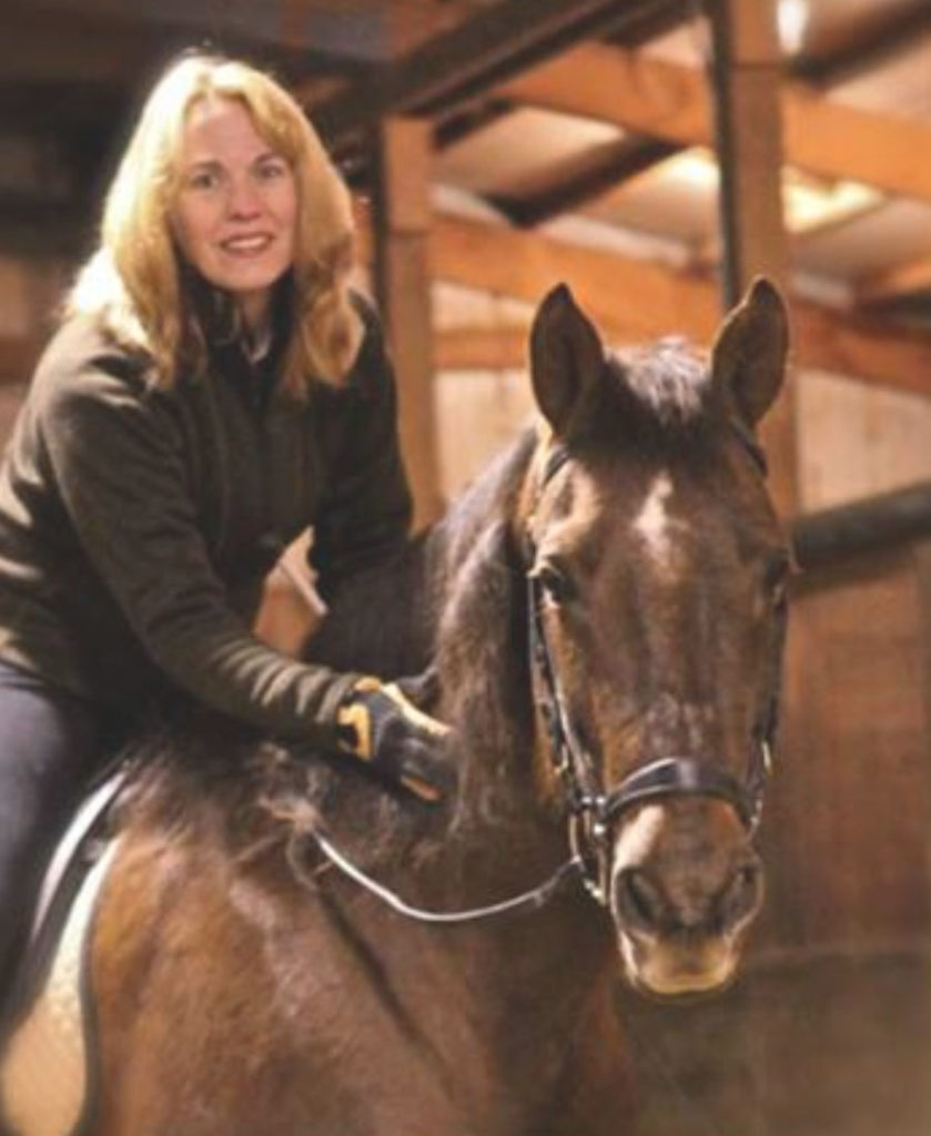 Blonde woman riding bay horse in English tack. Both looking directly into the camera. Copyright Margie Shoop. "The Breath of Horse Crazy"
