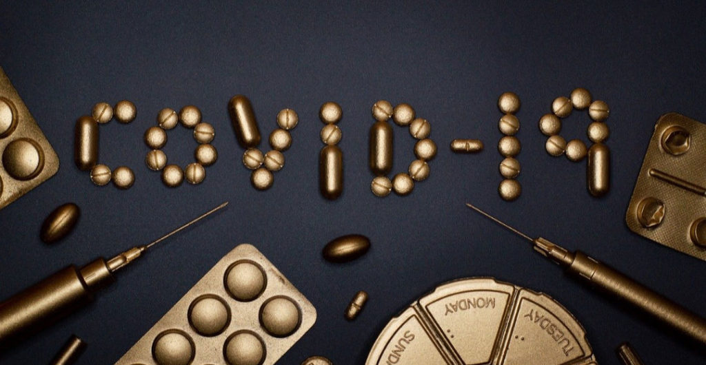 Bronze chemistry equipment spelling out COVID-19 on a dark background. The R-words of opportunity in global pandemic.