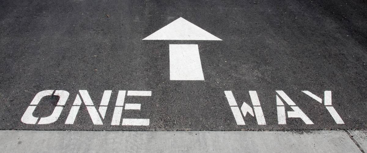 one way words and arrow painted on gray roadway. Jesus Christ is the only way